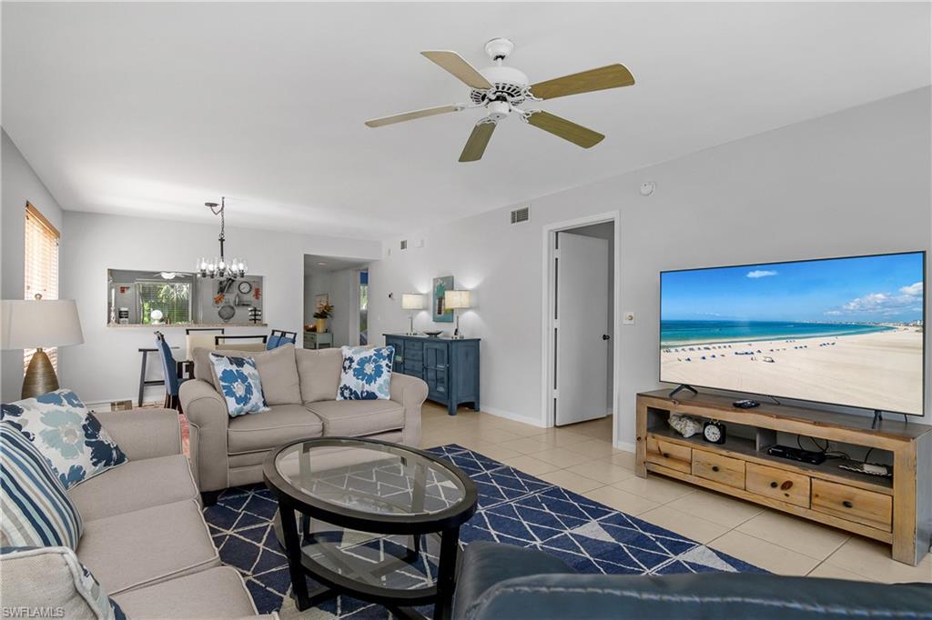 1330 Yesica Ann Circle, Unit I106 Naples, FL 34110 - Photo 6 of 38 a living room with furniture and a flat screen tv
