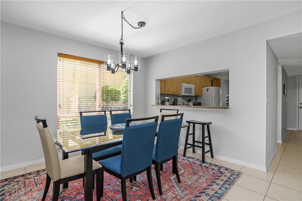 1330 Yesica Ann Circle, Unit I106 Naples, FL 34110 - Photo 7 of 38 a view of a dining room with furniture window and wooden floor