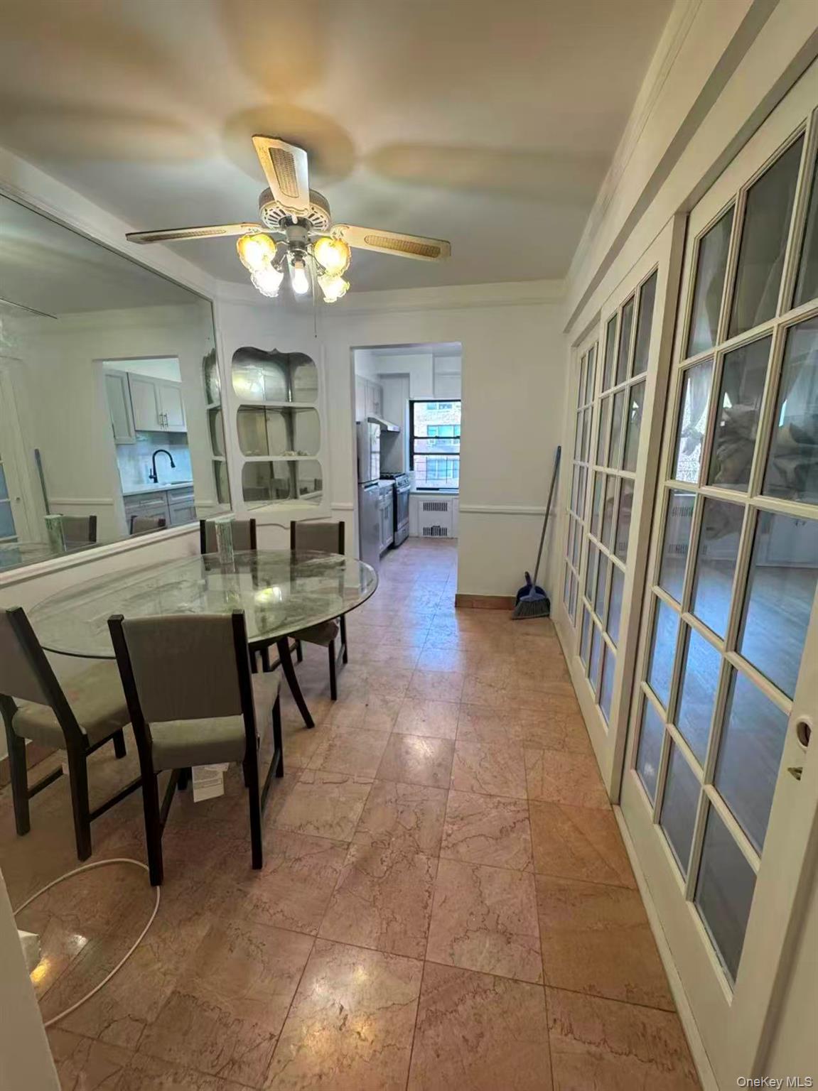 99-34 67th Road, Unit 5D Queens, NY 11375 - Photo 4 of 6 a view of a livingroom with furniture and a bookshelf
