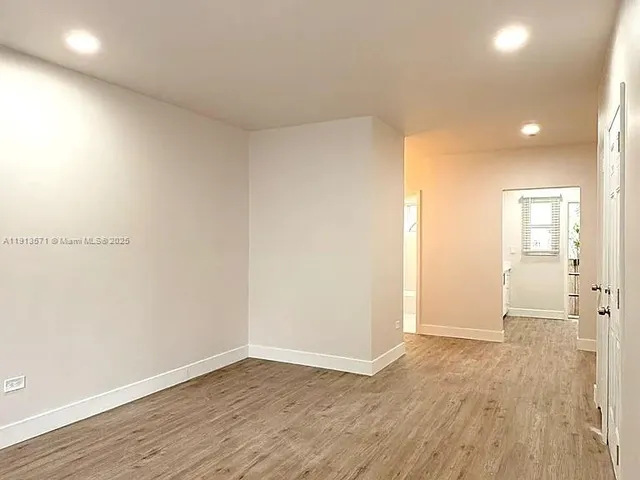 a view of an empty room and wooden floor