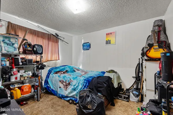 a bedroom with bed and a window