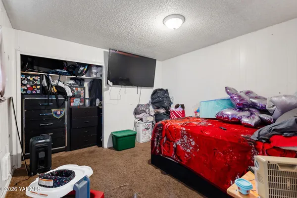 a bedroom with bed and a window