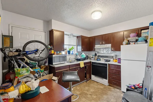 a kitchen with stainless steel appliances granite countertop a sink a stove and a refrigerator