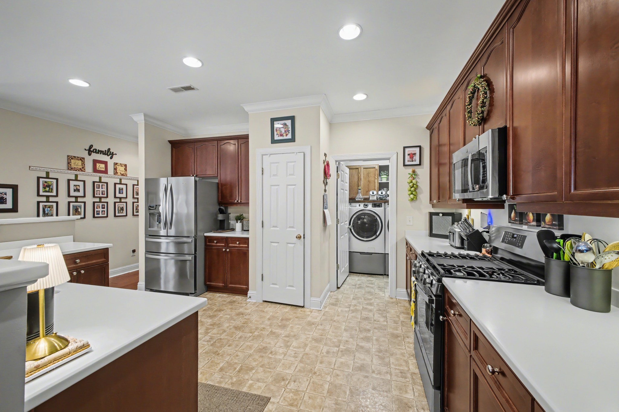213 Lilac Circle Franklin, TN 37064 - Photo 12 of 33 a kitchen with stainless steel appliances granite countertop a refrigerator stove top oven and sink