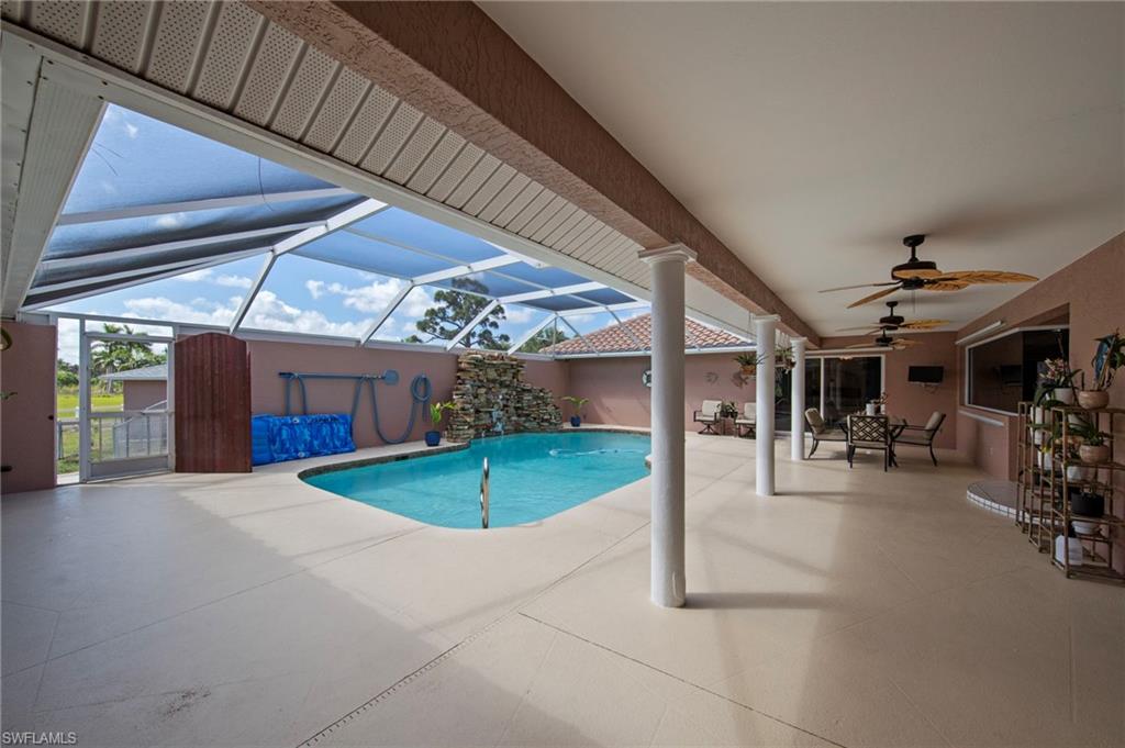 13541 Stringfellow Road Bokeelia, FL 33922 - Photo 32 of 49 a view of a patio with table and chairs under an umbrella