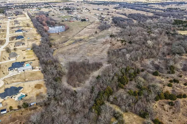 an aerial view of a houses with a yard