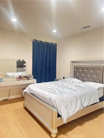 a bedroom with a bed and a dresser
