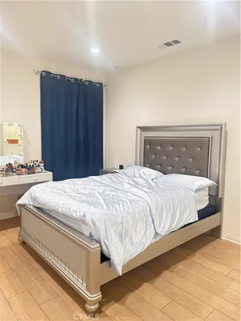 a large bed sitting in a bedroom and a mirror