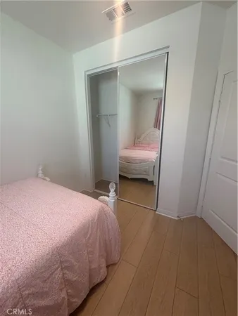 a bedroom with a bed and a mirror