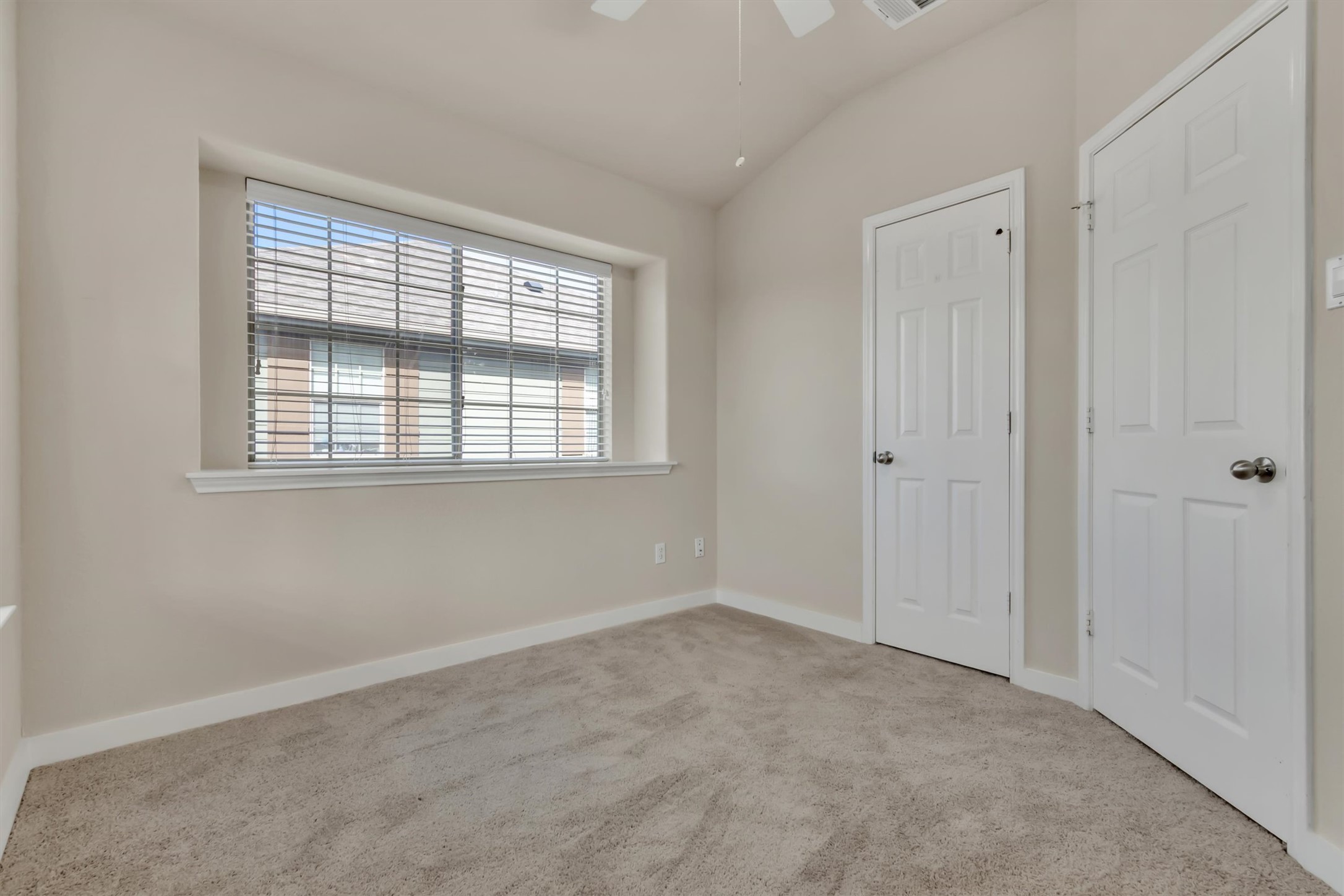 14815 Avery Ranch Boulevard, Unit 2A Austin, TX 78717 - Photo 13 of 27 A well-lit bedroom offering plush carpeting and ample natural illumination through its wide window.