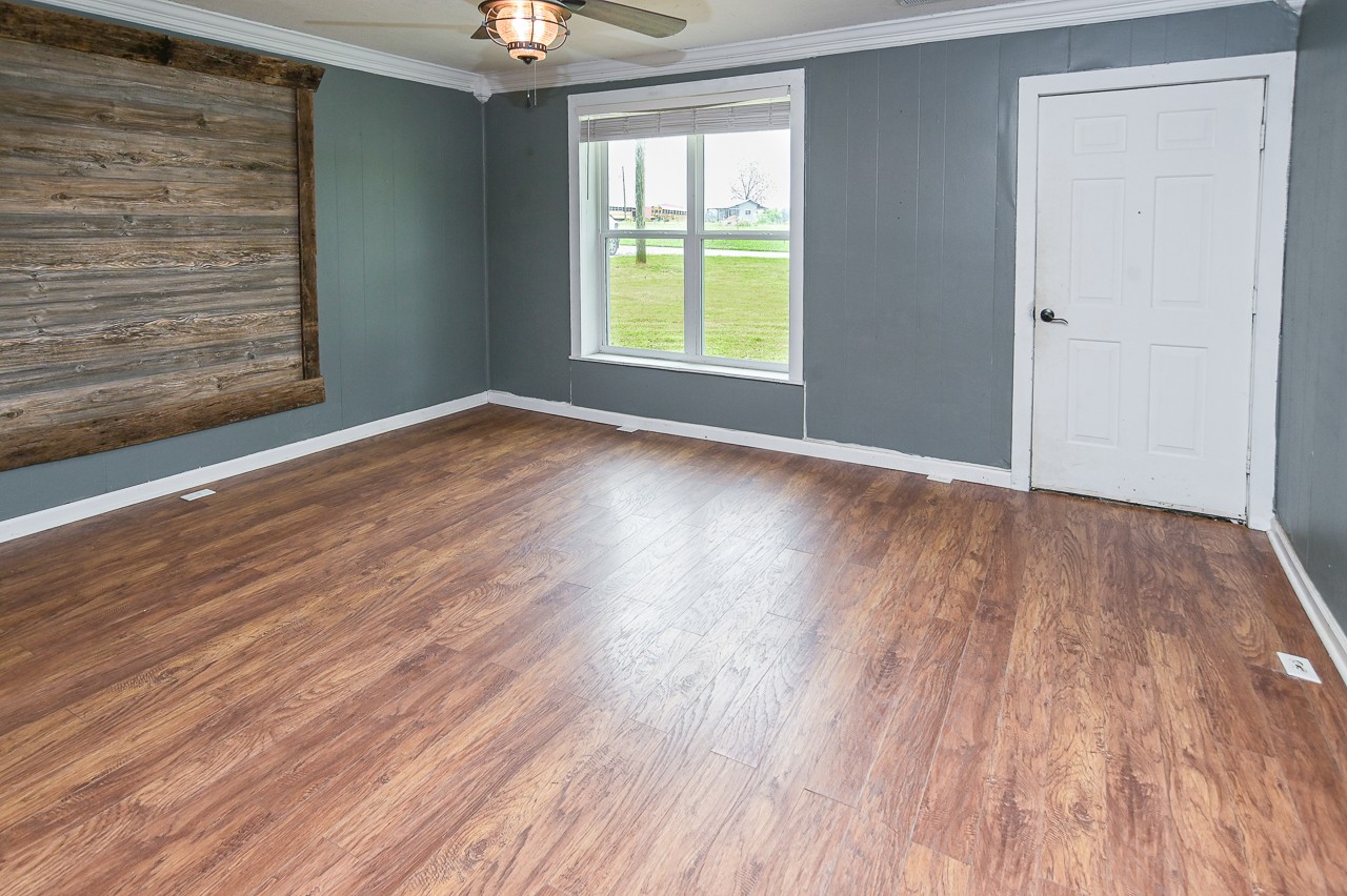 5 Layman Road Elora, TN 37328 - Photo 7 of 29 a view of an empty room with wooden floor and a window