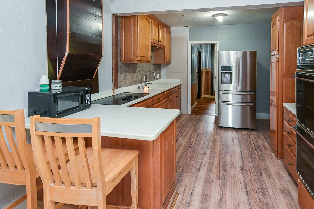 5 Layman Road Elora, TN 37328 - Photo 8 of 29 a kitchen with stainless steel appliances refrigerator microwave and stove