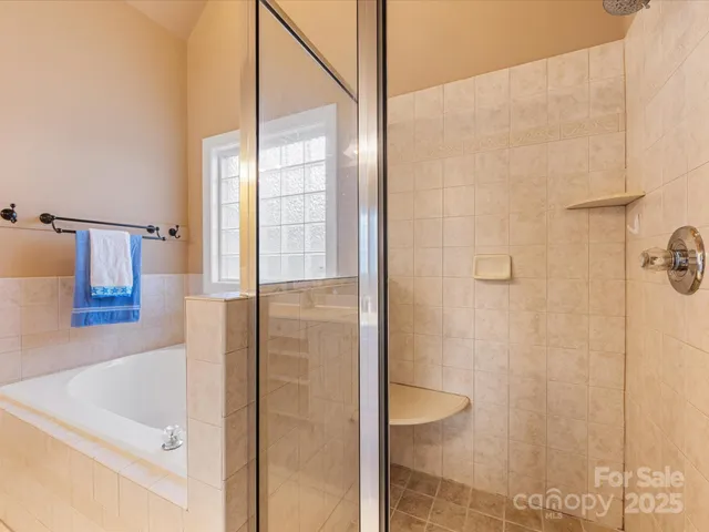 a bathroom with a bathtub and shower