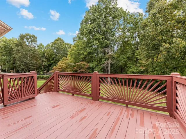 a balcony with wooden floor and fence