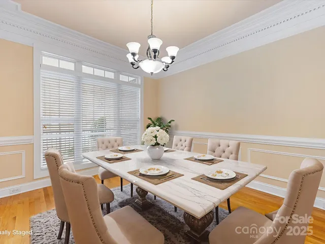 a view of a dining room with furniture wooden floor and chandelier