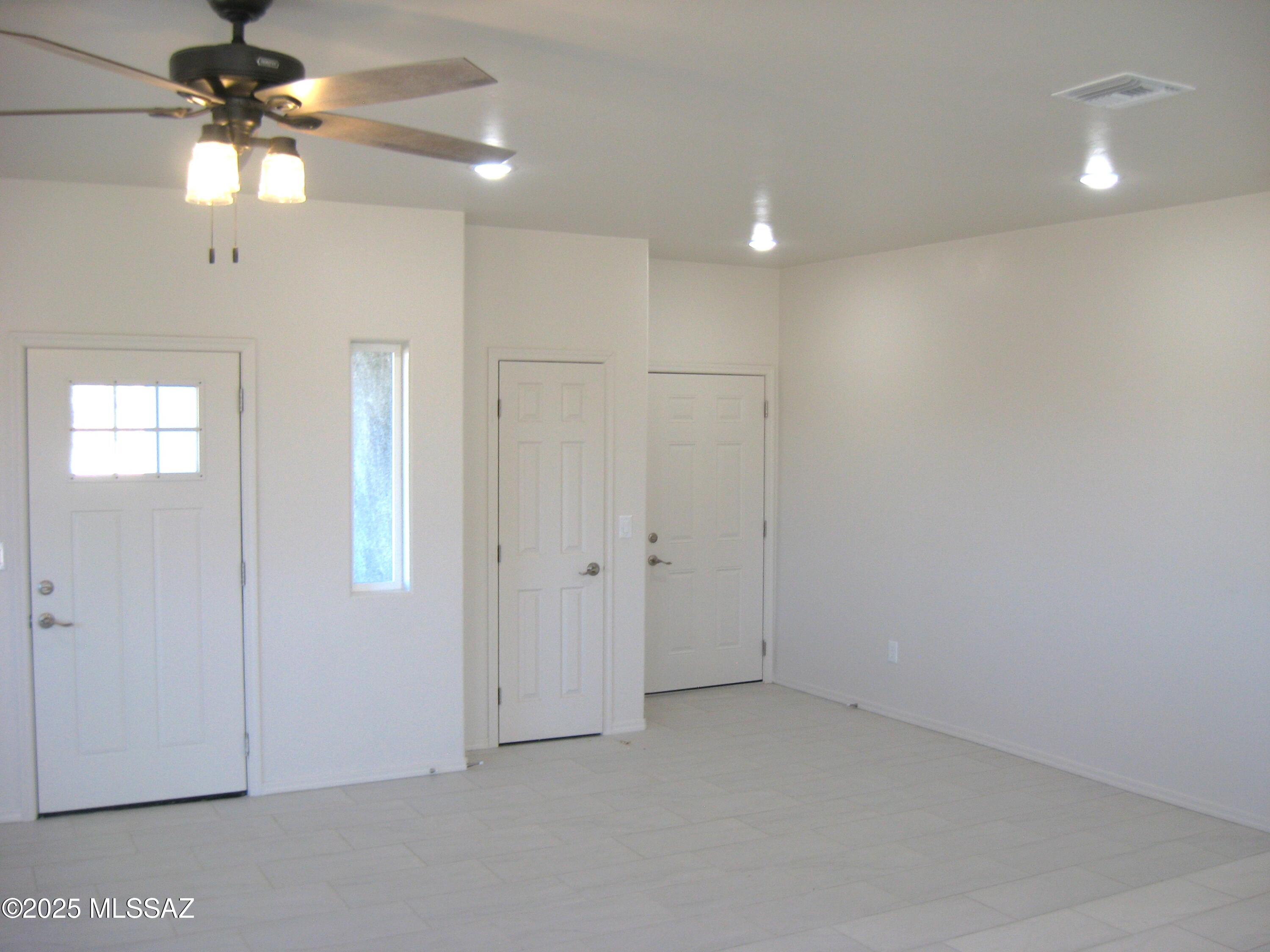 1734 Circulo Badajada Rio Rico, AZ 85648 - Photo 8 of 32 en empty room with windows and fan