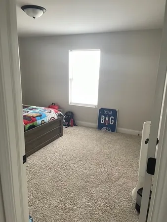 a bedroom with a bed and a television