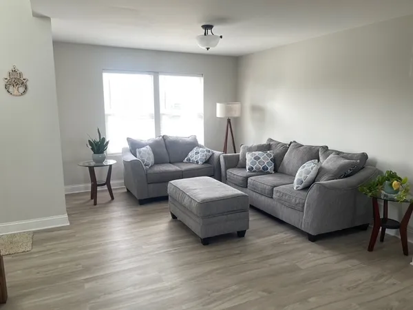 a living room with furniture and a window