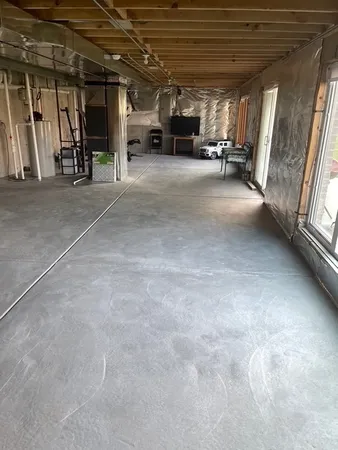 a view of empty room with wooden floor and fireplace