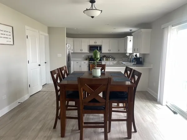 a view of a dining room with furniture and wooden floor