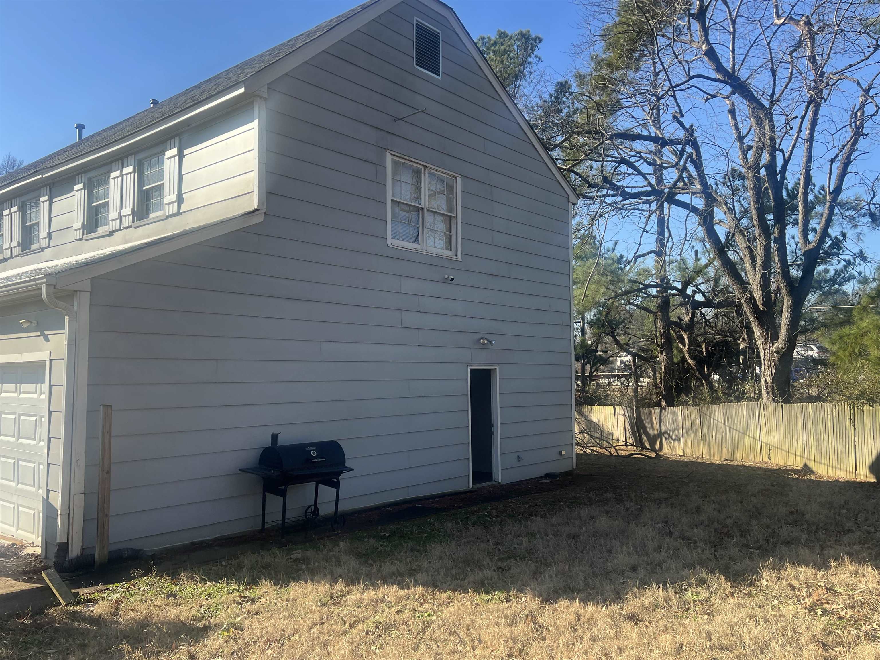 4295 Hudgins Road Memphis, TN 38116 - Photo 3 of 13 a view of a backyard with a large tree