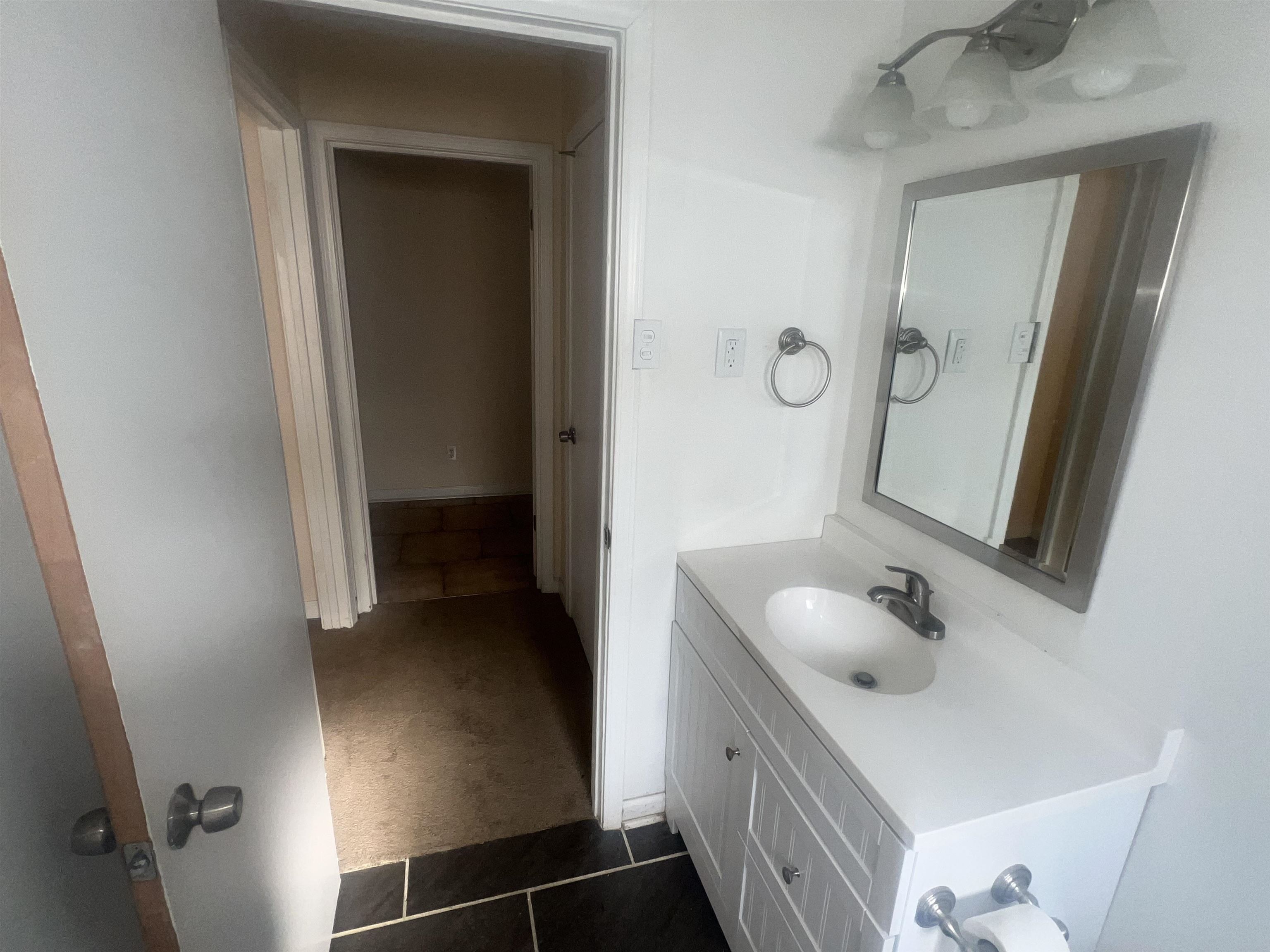 4295 Hudgins Road Memphis, TN 38116 - Photo 9 of 13 a bathroom with a sink vanity and mirror