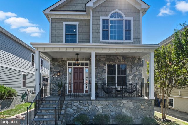 front view of a brick house with a yard