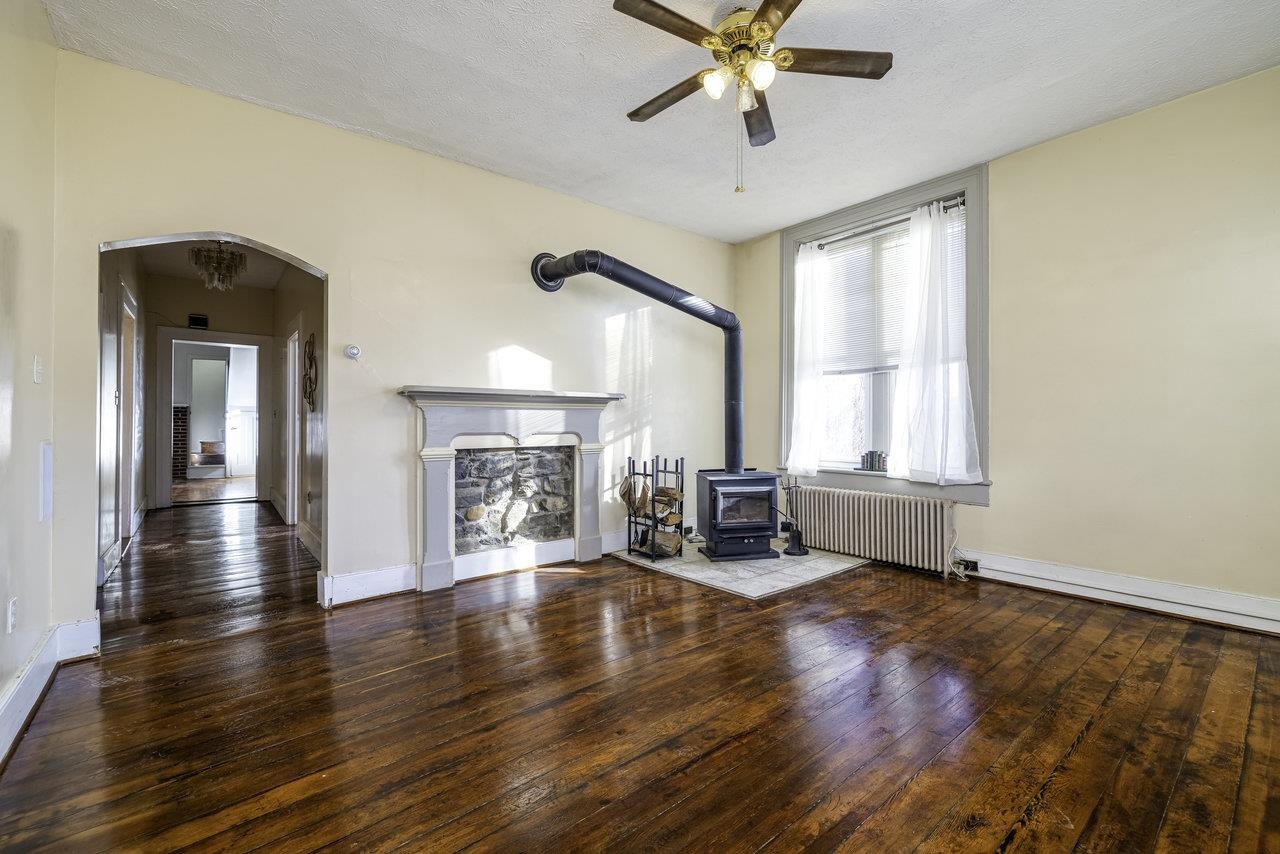 289 Brocks Gap Road Broadway, VA 22815 - Photo 13 of 46 a view of a livingroom with wooden floor a ceiling fan and windows