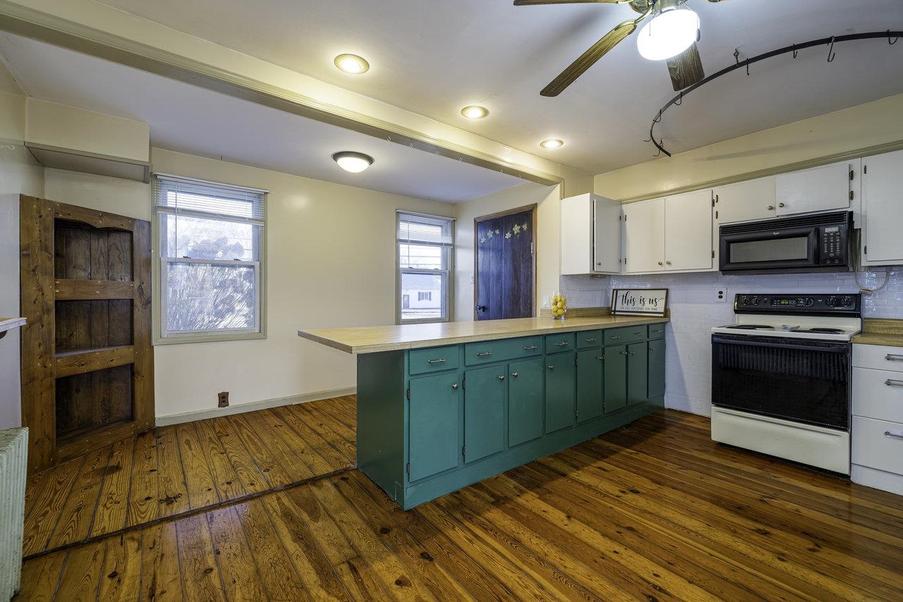 289 Brocks Gap Road Broadway, VA 22815 - Photo 4 of 46 a kitchen with granite countertop wooden floors and stainless steel appliances