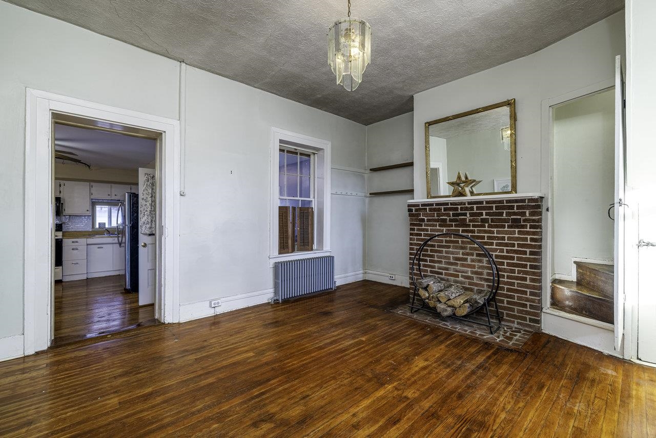 289 Brocks Gap Road Broadway, VA 22815 - Photo 8 of 46 a view of empty room with wooden floor and kitchen view