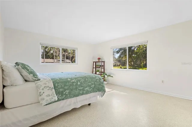 a dining room with wooden floor and a floor to ceiling window