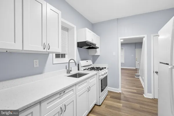 a kitchen with stainless steel appliances granite countertop a sink stove and cabinets