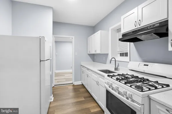 a kitchen with stainless steel appliances granite countertop a stove and a refrigerator
