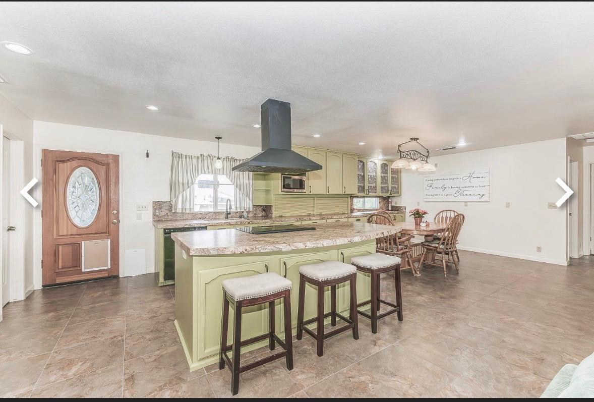 45991 Black Oak Road Coarsegold, CA 93614 - Photo 11 of 49 a large kitchen with a table and chairs