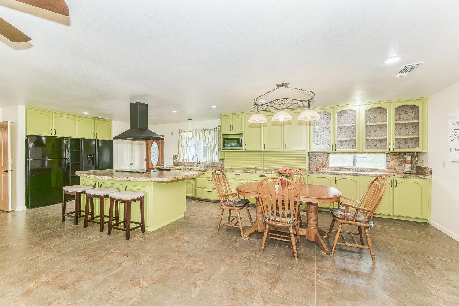45991 Black Oak Road Coarsegold, CA 93614 - Photo 11 of 67 a view of a dining room with furniture and chandelier