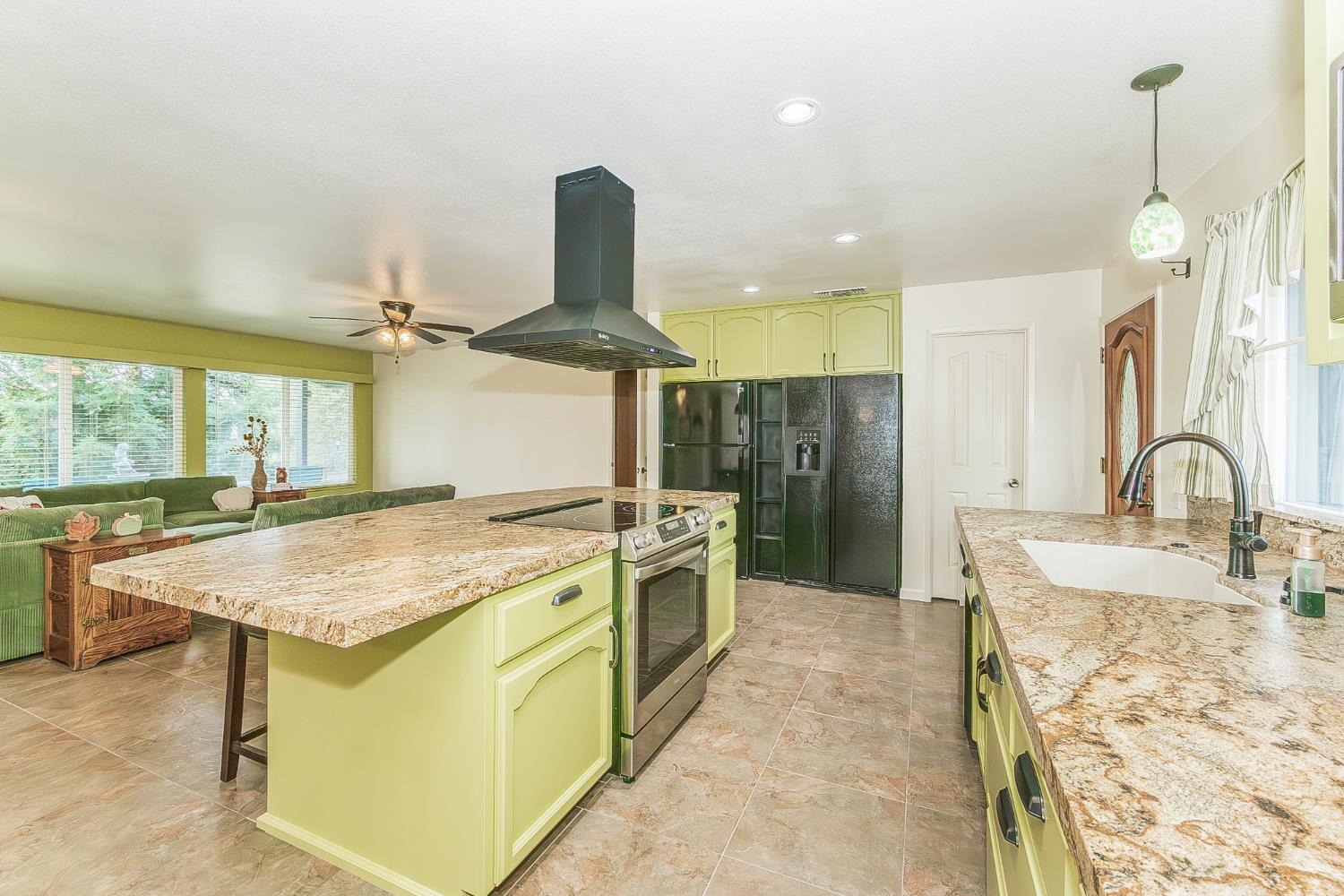 45991 Black Oak Road Coarsegold, CA 93614 - Photo 13 of 67 a kitchen with a sink a stove and refrigerator