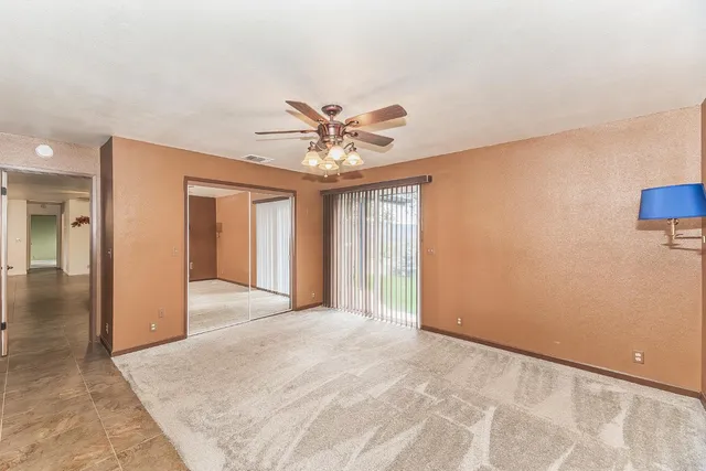 a large bathroom with a granite countertop sink and a large mirror