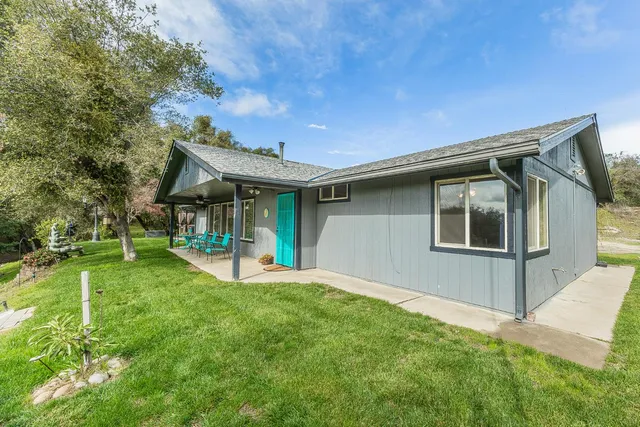 a front view of house with a garden