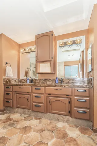 a kitchen with stainless steel appliances kitchen island granite countertop a refrigerator and a sink