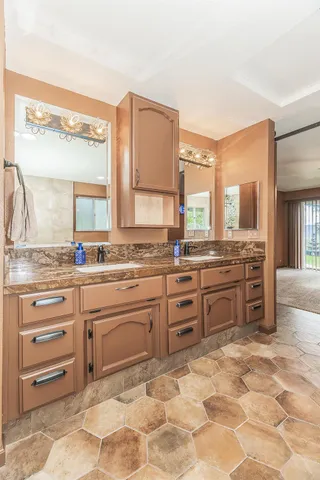 a living room with a bed furniture and a kitchen view