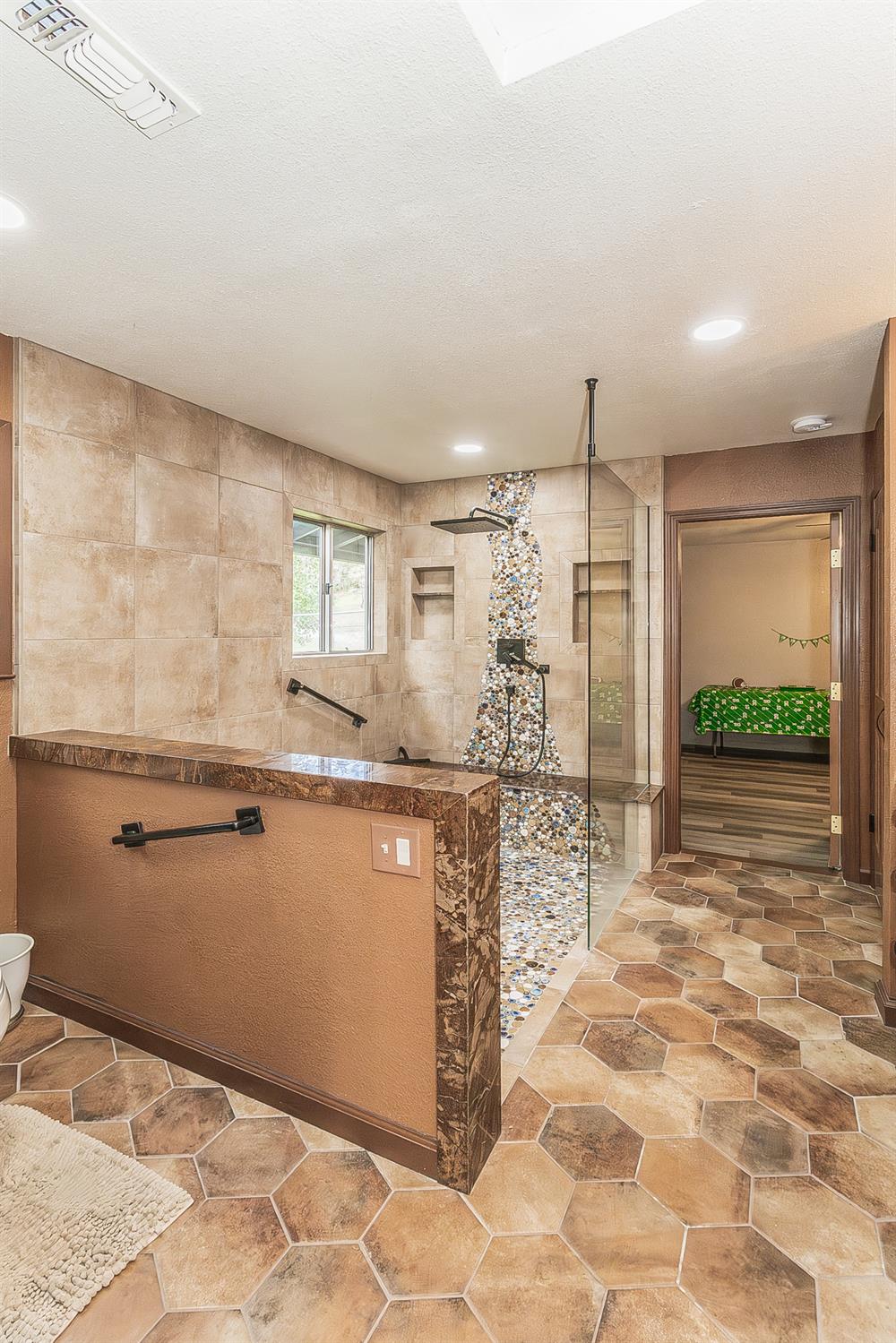 45991 Black Oak Road Coarsegold, CA 93614 - Photo 23 of 67 a kitchen with stainless steel appliances kitchen island granite countertop a refrigerator and a sink