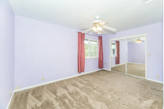 a view of a backyard with table and chairs and a large tree
