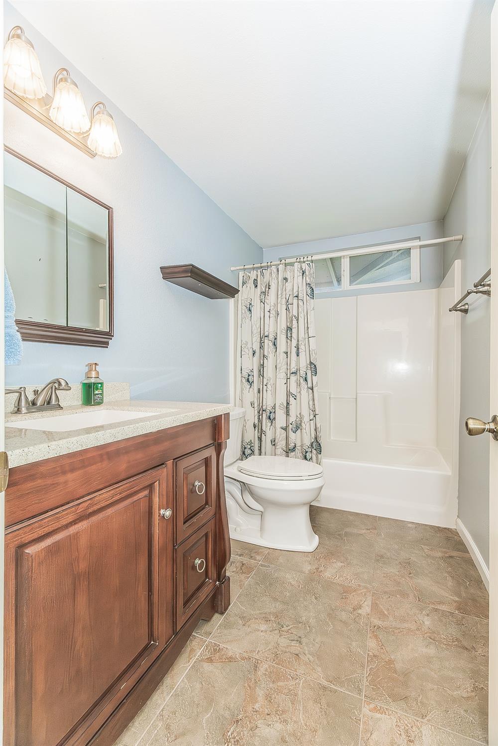 45991 Black Oak Road Coarsegold, CA 93614 - Photo 32 of 67 a spacious bathroom with a double vanity sink toilet and shower
