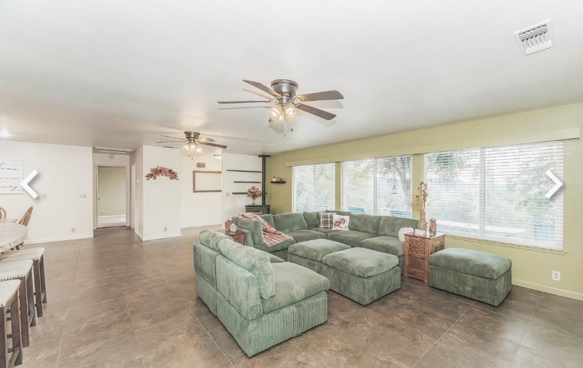 45991 Black Oak Road Coarsegold, CA 93614 - Photo 9 of 49 a living room with furniture and a large window with kitchen view