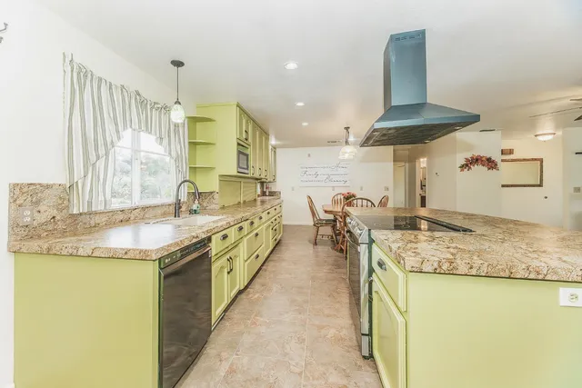 a view of a dining room with furniture and chandelier
