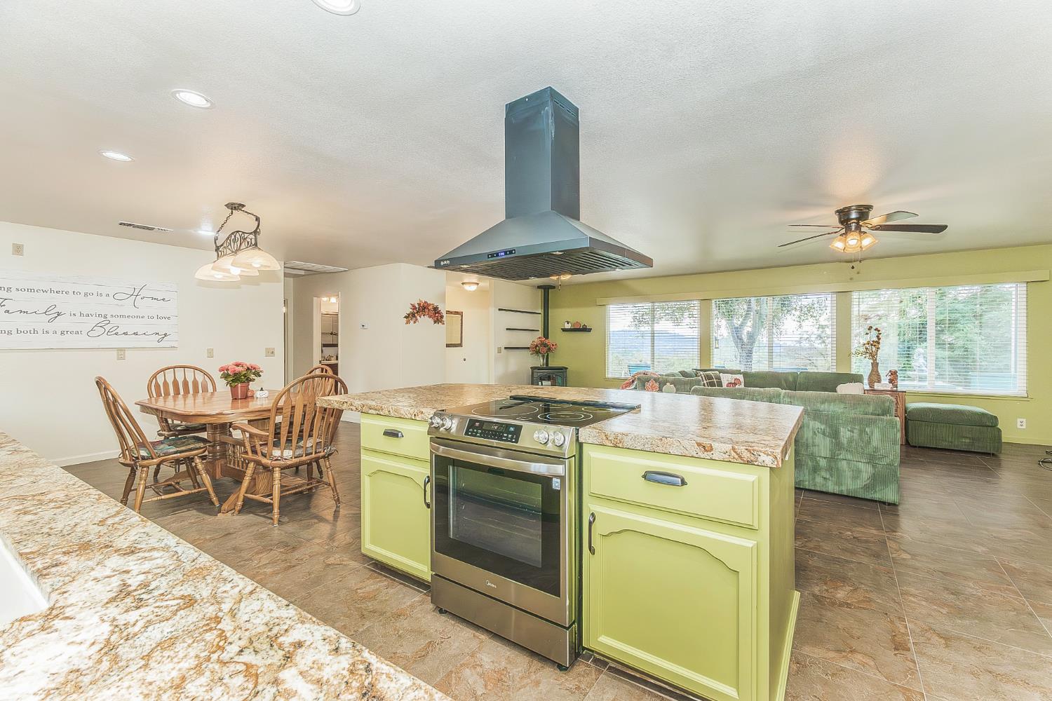 45991 Black Oak Road Coarsegold, CA 93614 - Photo 10 of 67 a kitchen with stove and chairs