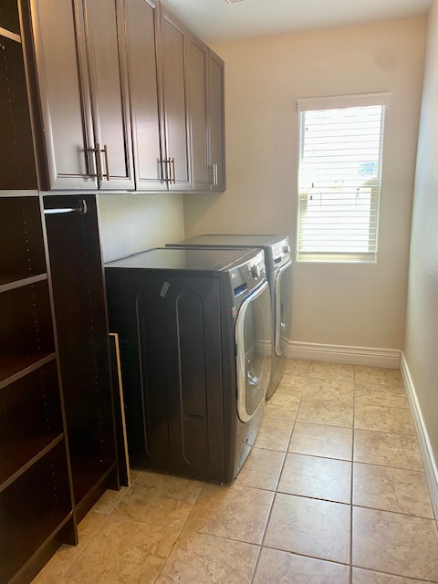 159 Tall Ruff Drive Las Vegas, NV 89148 - Photo 23 of 31 Ample built-in cabinetry and durable tile flooring highlight this functional laundry space.