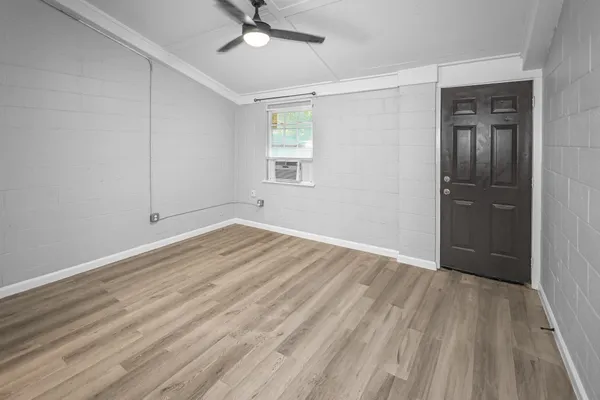 wooden floor in an empty room with a window