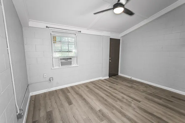 wooden floor in an empty room with a window