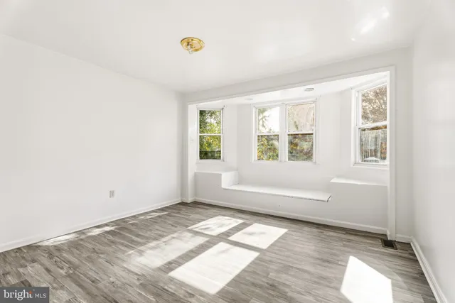 a view of a room with wooden floor